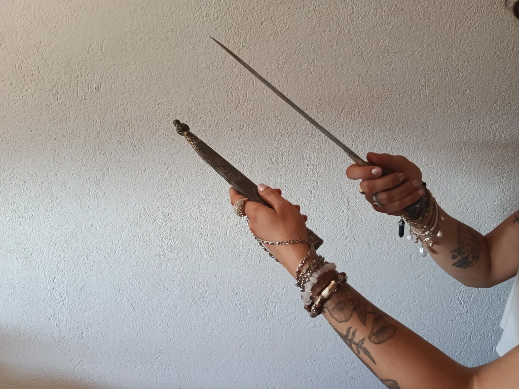 Hands holding ritual tools used in symbolic and contemplative practices.