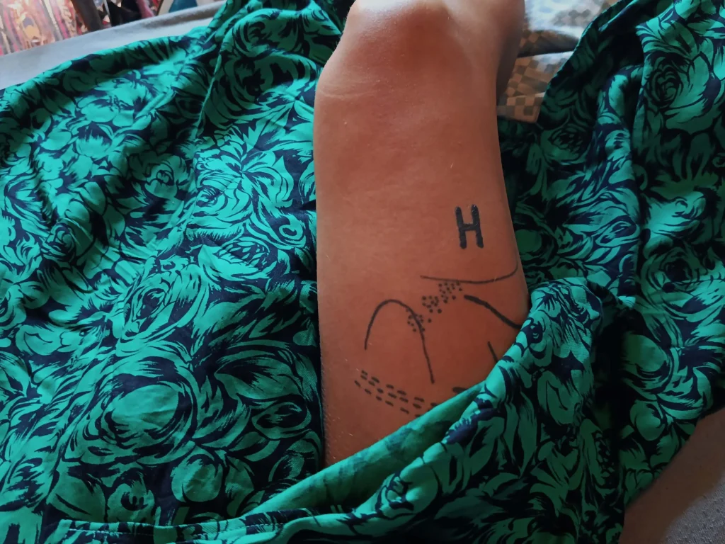 Self-tattooing letter H inspired by Tool's song H., exploring themes of symbolism, identity, sovereignty, and personal transformation.