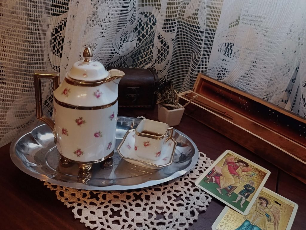 Tarot cards placed beside a coffee in a contemplative reading space.