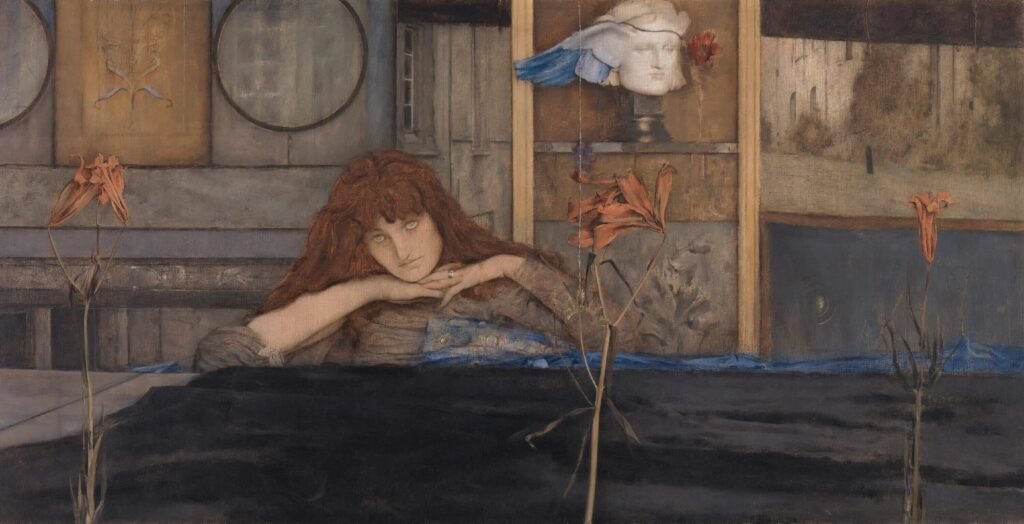 Red-haired woman resting her chin on her hands behind orange flowers, with a winged sculpted head in the background.
