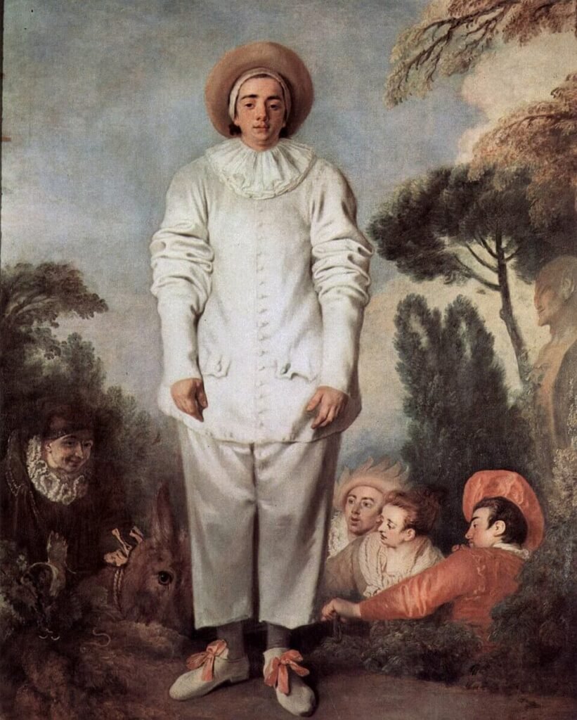 A man in a loose white theatrical costume stands facing the viewer, with other costumed figures and trees behind him.