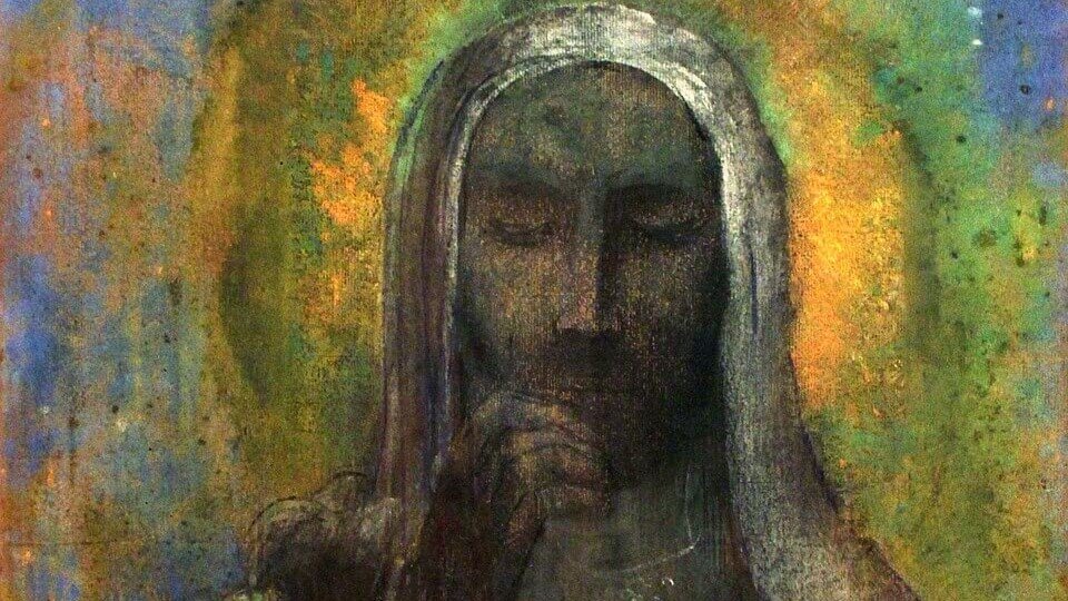 Veiled Christ with lowered eyes and a hand raised to his lips, surrounded by a yellow halo against a muted blue background.