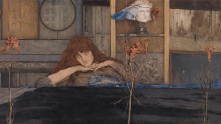 Red-haired woman resting her chin on her hands behind orange flowers, with a winged sculpted head in the background.